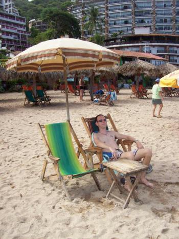 Andrew Wharon relaxes in Puerto Vallarta beach near Blue Chairs bar